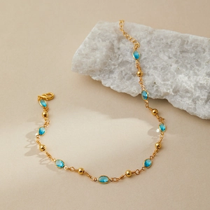 Bohemian gold plated anklet featuring sky blue oval stones and delicate chain link