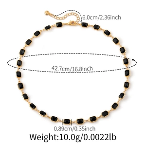 Detailweergave van de verstelbare gouden ketting en maten van de zwarte hanger in smaragdslip