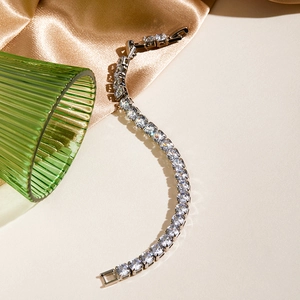 Macro detail of silver tennis bracelet with cubic zirconia and folding clasp