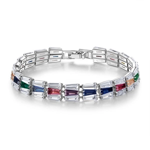 Detailed close-up of rainbow crystal tennis bracelet with silver finish and secure clasp