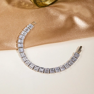 Detailed macro view of silver tennis bracelet with rectangular crystals and secure clasp