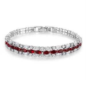 Close-up of triple-row tennis bracelet with red oval stones and sparkling crystals