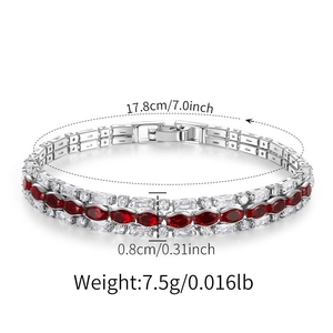 Detailed view of silver bracelet with red marquise gems and clear zircon inlay
