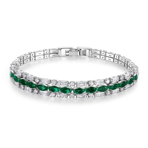 Macro view of silver bracelet featuring green emerald-cut stones and white zircon crystals