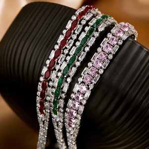 Close-up of luxury flower tennis bracelets with vibrant red, green, and pink gemstones