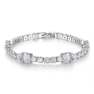 Macro shot of silver tennis bracelet with round and square cut sparkling zircons