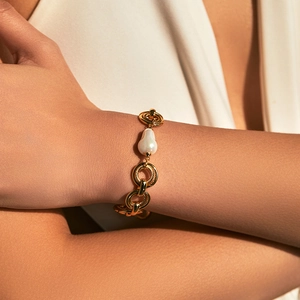 Elegante bracciale a catena placcato oro 18 carati con perla barocca sul polso di donna