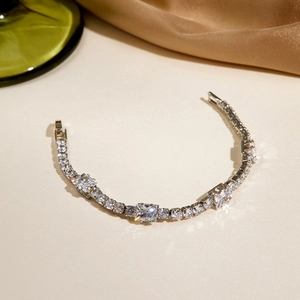 Detailed close-up of sparkling tennis bracelet with round and rectangular crystals