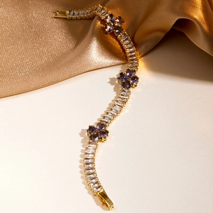 Detail of 18K gold plated bracelet featuring purple heart zircons and rectangular stones