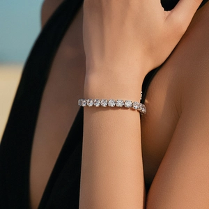 Elegant silver tennis bracelet with sparkling round zircons worn on woman wrist