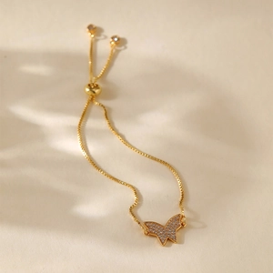 Detail of gold butterfly bracelet featuring sparkling zircon stones and adjustable drawstring