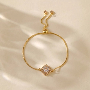 Detail of adjustable gold box chain bracelet with square crystal centerpiece and bolo clasp