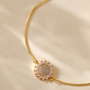 Detailed macro of gold-plated sunflower bracelet with radiant pavé zircon petals