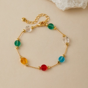 Detail of gold chain bracelet with colorful multi-faceted glass beads and adjustable clasp
