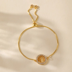 Detail of gold tree of life bracelet with white zircon inlay and adjustable slide clasp