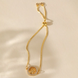 Macro detail of adjustable gold tree of life bracelet with white zircon stones