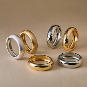 Detail showing gold and silver textured alloy bangles with matte, hammered, and mirror finishes