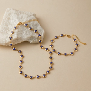 Bohemian gold plated jewelry set featuring blue heart-shaped charms and link chains