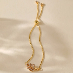 Detail of gold-plated leaf charm with white zircons and adjustable sliding ball clasp