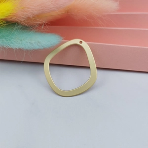 Macro shot of irregular matte gold geometric charm for DIY earring and jewelry making