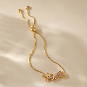Detailed macro of gold plated Love adjustable bracelet with sparkling crystal inlay