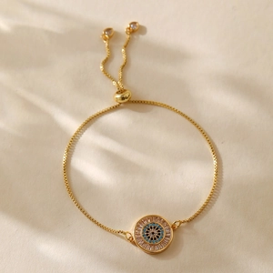 Detail of adjustable gold evil eye bracelet with blue crystals and sparkling cubic zirconia