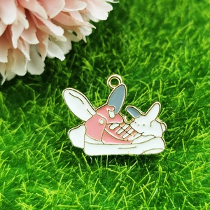 Detail of pink cartoon high-top sneaker and white bunny enamel charm for DIY jewelry