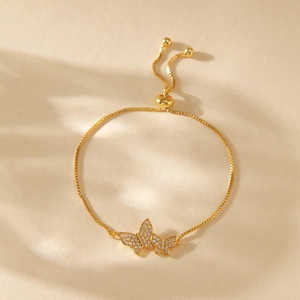 Detailed view of adjustable gold butterfly bracelet with white zircon pave setting