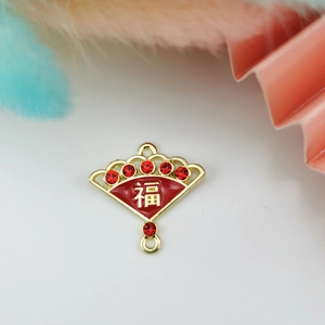 Detail showing red enamel Chinese fan charm with Fu character and sparkling crystals