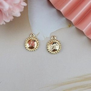 Detailed macro of gold lucky charms with Fu character and Good Luck text for DIY jewelry