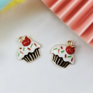 Macro shot of 3D enamel strawberry cupcake charms with gold-plated rings for DIY jewelry