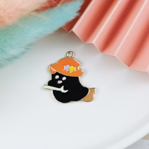 Detail of alloy cartoon ghost charm with orange wizard hat and bone for DIY jewelry