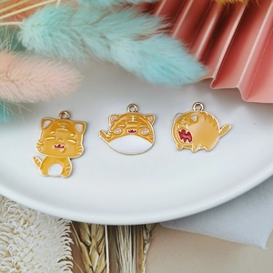 Three cute yellow alloy tiger charms with drip oil finish and gold edges for DIY jewelry