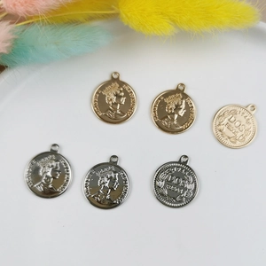 Detailed view of gold and silver coin pendants with embossed Queen Elizabeth II for DIY jewelry