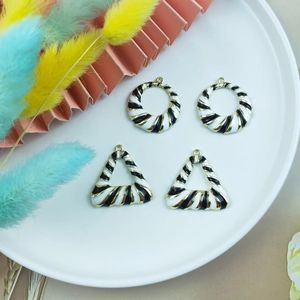 Minimalist gold alloy pendants with black and white spiral patterns in round and triangle shapes