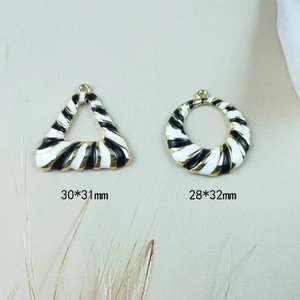 DIY enamel charms set with black and white striped geometric triangle and ring shapes