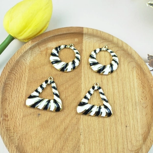 DIY jewelry charms with black and white striped enamel and gold-plated geometric frames