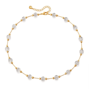 Detailed macro view of the adjustable lobster clasp and gold chain with clear glass beads