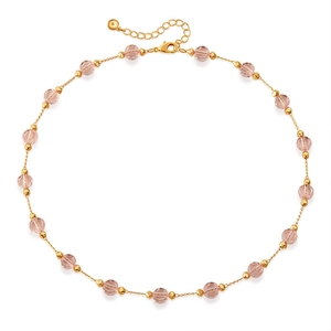 Close-up of pink glass beaded necklace with gold lobster clasp and extension chain