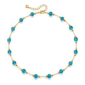 Detail of blue glass beads and gold spacers on a summer necklace with lobster clasp