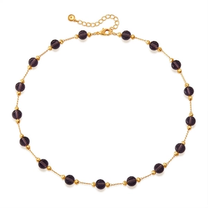 Detailed shot of dark purple faceted beads with golden diamond spacers and lobster clasp