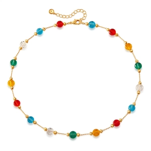 Detail of colorful faceted glass beads on a gold chain with lobster clasp and extender