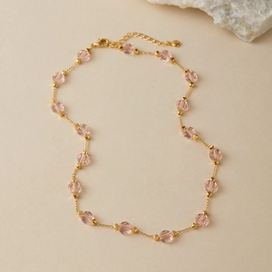 Detail of pink glass beads and gold-plated chain necklace with lobster clasp and extender