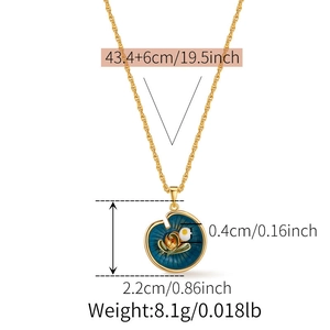 Detailed view of enamel pendant necklace with flower and pearl details on golden chain