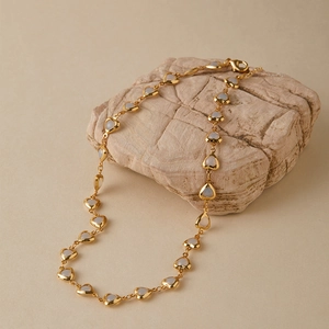 Macro detail of French vintage heart necklace with mother of pearl on stone base