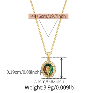 Detailed close-up of oval vintage rose pendant necklace with green shell inlay and crystals