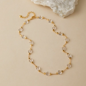 Close-up of pearl necklace with 18K gold plated faceted glass beads and lobster clasp