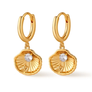 Macro shot of gold plated shell earrings with zircon stone and starfish detail