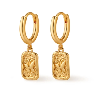 Detail of gold hoop earrings with rectangular butterfly relief and textured surface