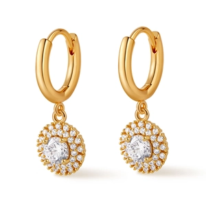 Detailed macro view of gold hoop earrings with sparkling circular diamond-studded pendants